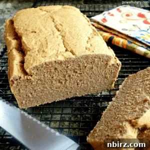 loaf of lentil bread, sliced, on a black cooling rack