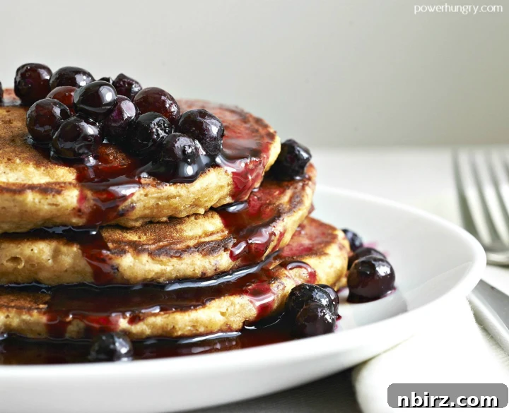 A short stack of delicious 3-ingredient vegan chickpea flour pancakes on a white plate, ready to be enjoyed.