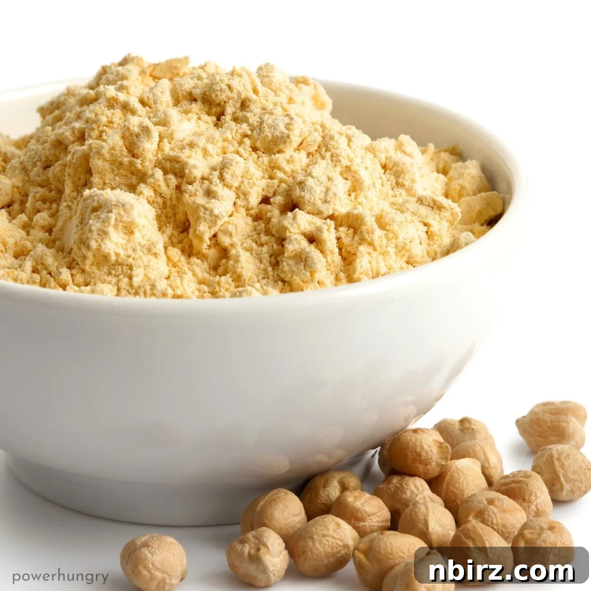 A white bowl filled with fine, golden chickpea flour, highlighting its pure and natural state.