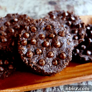 Appetizing photo of a batch of 100% flax chocolate cookies, showcasing their inviting texture and rich chocolate color.