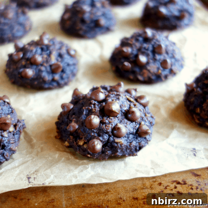 Healthy chocolate banana oat cookies on a baking sheet, showcasing their wholesome appeal and perfect golden-brown finish.
