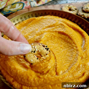 Overhead view of a vibrant vegan nut-free nacho cheese dip in a bowl.
