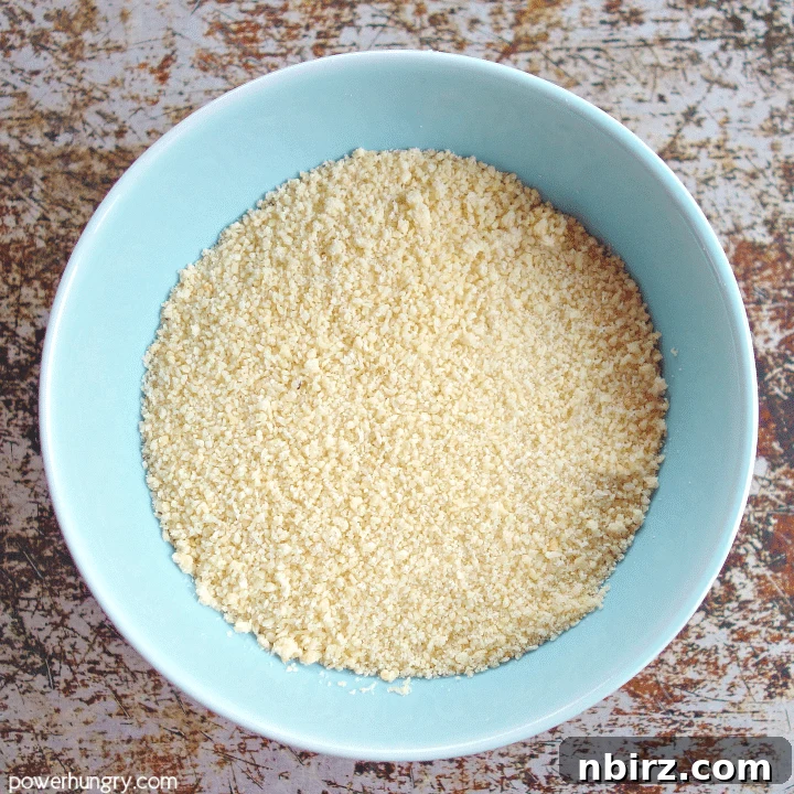 Small light blue bowl filled with finely ground almond flour, a key ingredient for gluten-free baking.
