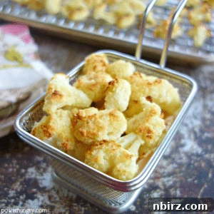 A square image of crispy golden cauliflower popcorn in a small white bowl, ready to be served.
