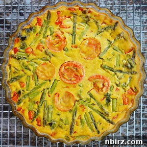 3-Ingredient Wonder: Vegan Oil-Free Chickpea Frittata 2 A mouthwatering photo of the finished Vegan Chickpea Flour Frittata, golden and rich with vegetables, perfectly sliced and ready to be served. It appears wholesome and inviting.