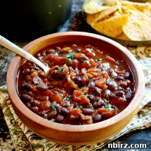 Delicious 3-ingredient black bean chili in a wooden bowl