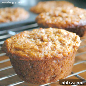 Close-up of a vegan cinnamon quinoa oat muffin on a cooling rack, perfectly golden and inviting