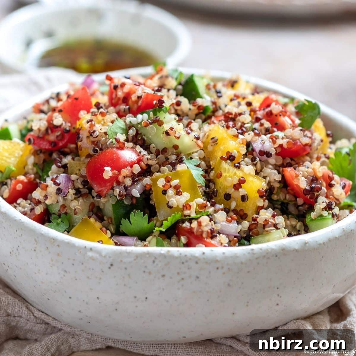 Vibrant Oil-Free Quinoa Bowl 3 Close-up view of the wholesome oil-free quinoa salad, featuring finely diced vegetables and fluffy quinoa, ready to be enjoyed.