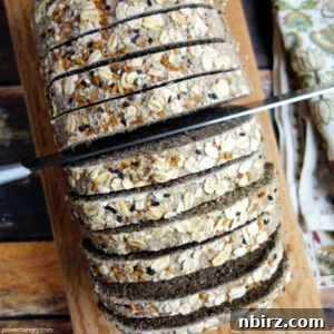 Effortless Gluten-Free Buckwheat Bread Without Yeast Or Oil 2 Overhead shot of buckwheat bread being sliced with a serrated knife.
