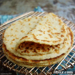 Stack of almond tortillas on a copper wire rack