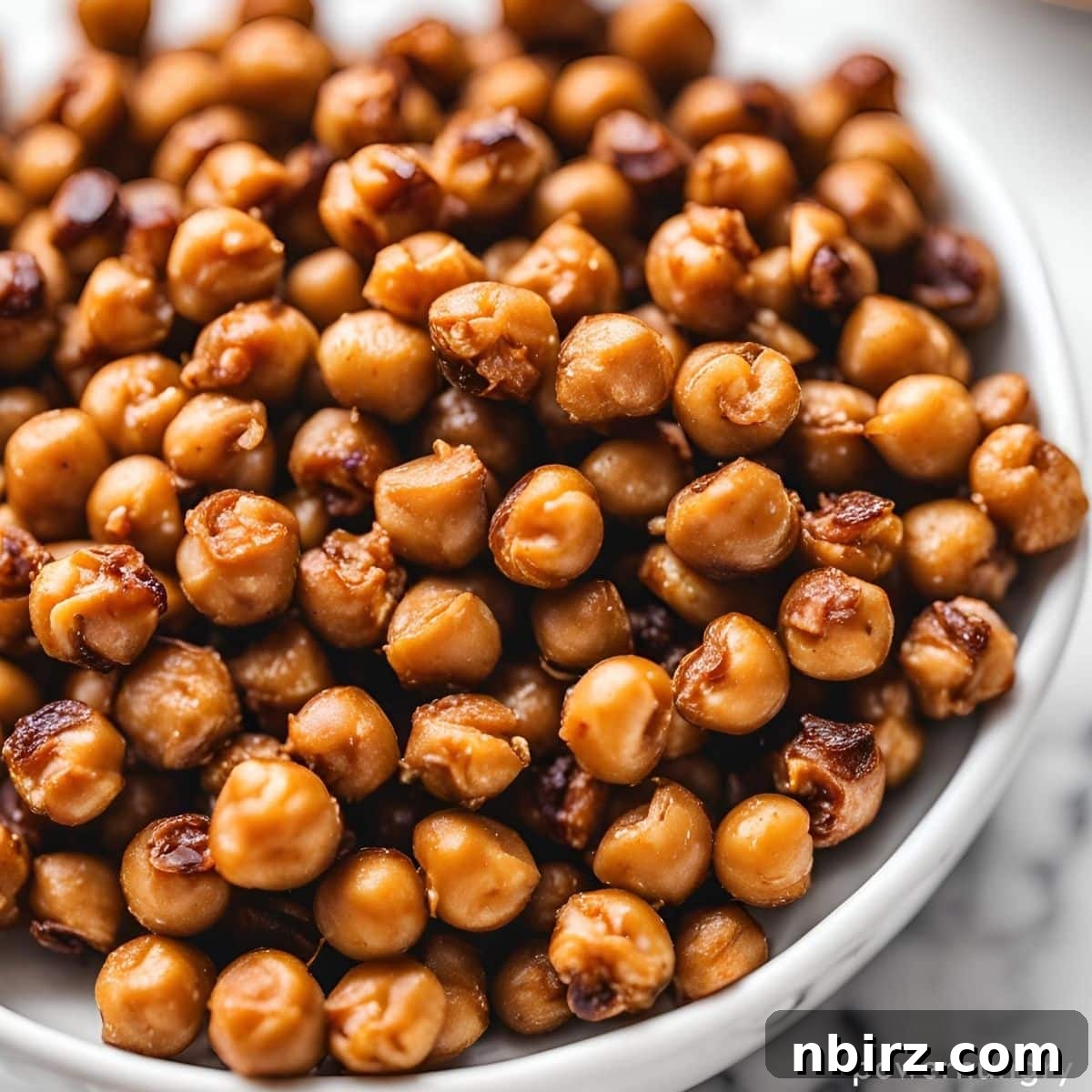 Guilt-Free Crispy Protein Chickpeas 3 crispy roasted chickpeas in a large white bowl