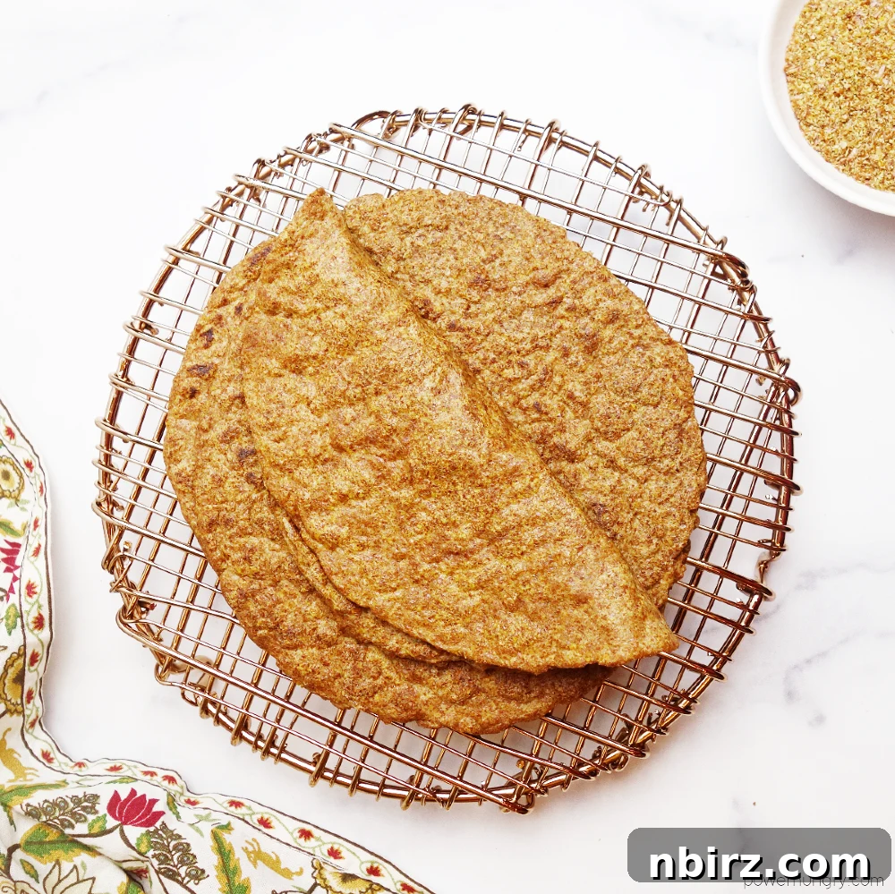 Effortless Keto Flaxseed Wraps 2 Overhead shot of golden brown flax tortillas on a copper wire rack, showcasing their texture and perfect round shape.