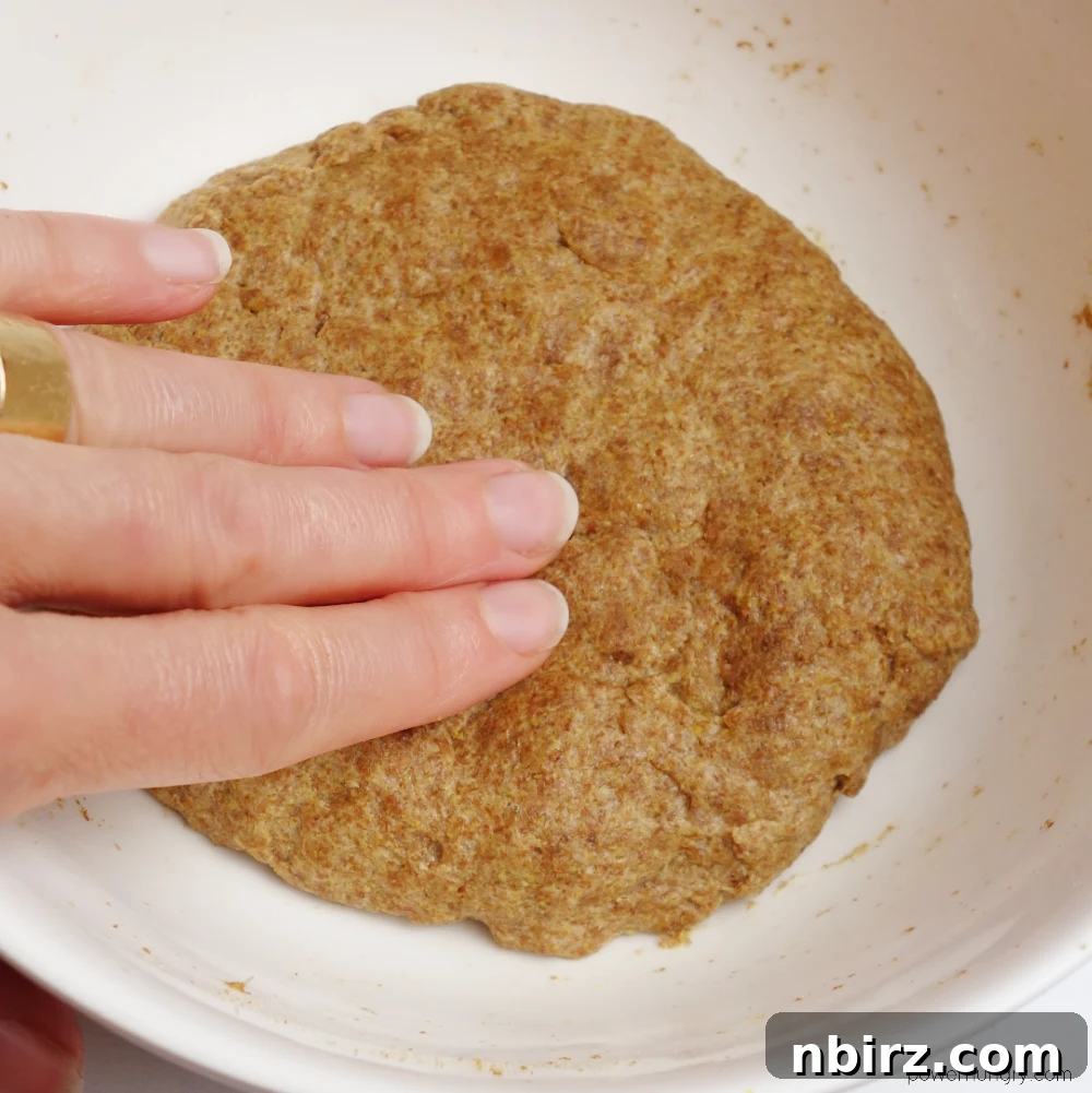 Effortless Keto Flaxseed Wraps 6 Flax tortilla dough resting in a white bowl, showcasing its smooth and slightly sticky texture.