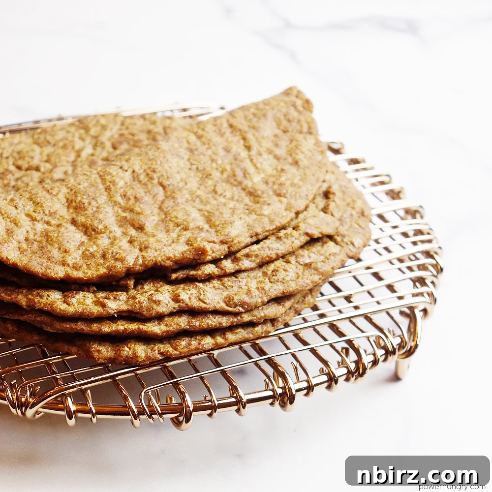 Effortless Keto Flaxseed Wraps 9 A stack of perfectly cooked flax tortillas cooling on a copper wire rack, ready to be used in your favorite recipes.
