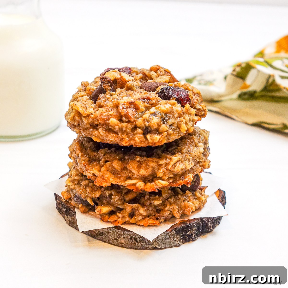 Wholesome Two-Ingredient Banana Oat Cookies 3 A stack of three golden brown 2-ingredient banana oat cookies, showcasing their inviting texture.