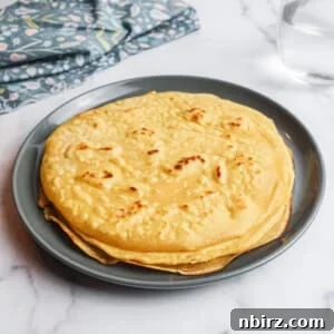 Two ingredient grain-free vegan tortillas stacked with various fillings around them.