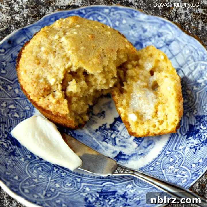 Golden Toasted Millet Banana Muffins Vegan Gluten Free 4 A perfectly baked banana millet muffin, split open and showing its moist interior, spread with vegan butter on a blue and white plate