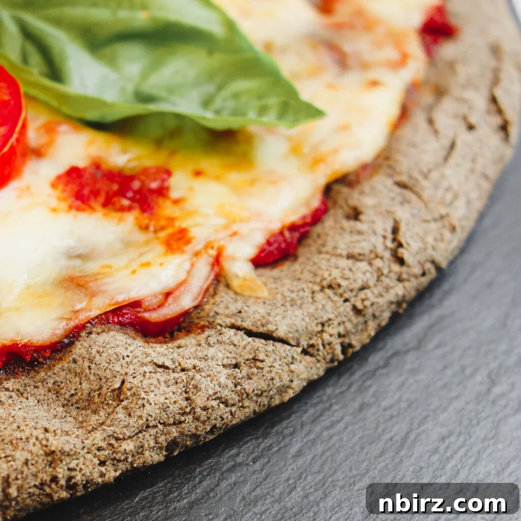 Two-for-Tea Buckwheat Pizza: Simplicity on a Slice 10 Close-up of a slice of buckwheat pizza, showcasing the texture of the crust.