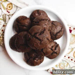 Close-up of a stack of vegan chocolate buckwheat cookies, showcasing a soft texture and melted chocolate chips.