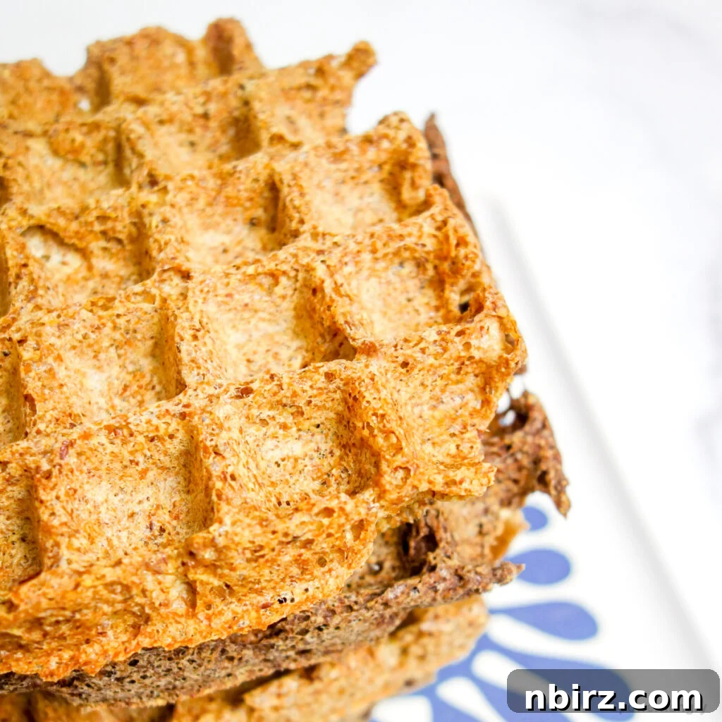 One-Bowl Vegan Flax Waffles (Keto, Gluten-Free Option) 12 Stack of flax waffles on a blue and white plate, showcasing their versatility as a bread alternative