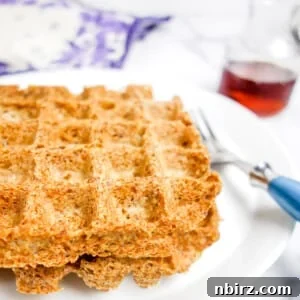 two flax waffles on a white plate