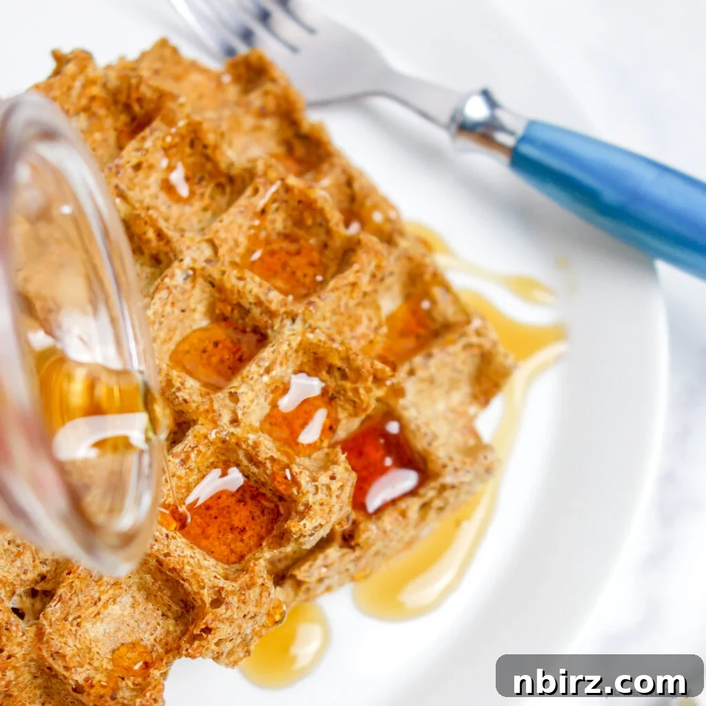 One-Bowl Vegan Flax Waffles (Keto, Gluten-Free Option) 3 Flax waffles drizzled with maple syrup, a perfect breakfast treat