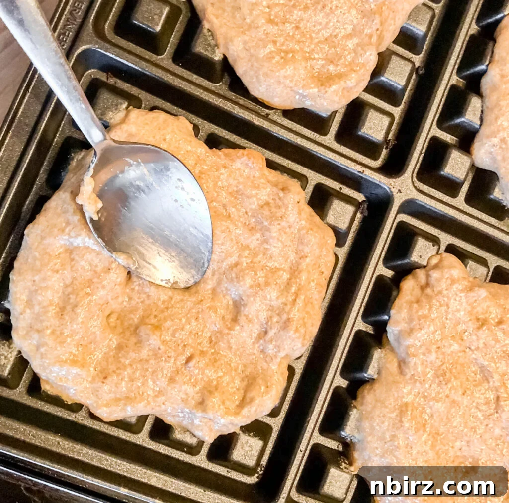 One-Bowl Vegan Flax Waffles (Keto, Gluten-Free Option) 9 Flax waffle batter spread evenly onto the plates of a waffle maker, ready for cooking