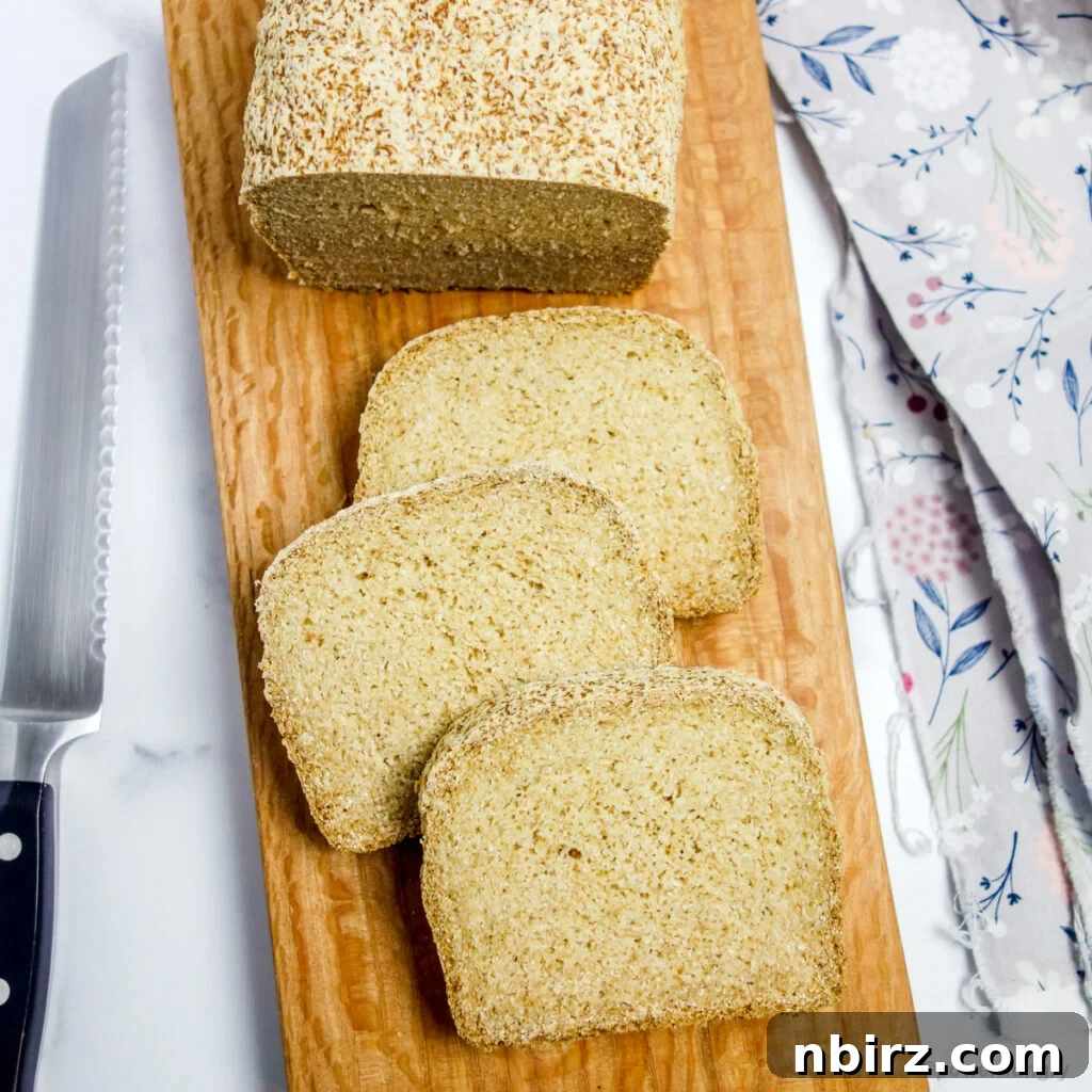 Delicious coconut flour sandwich bread on a rustic wooden board, ready for slicing.