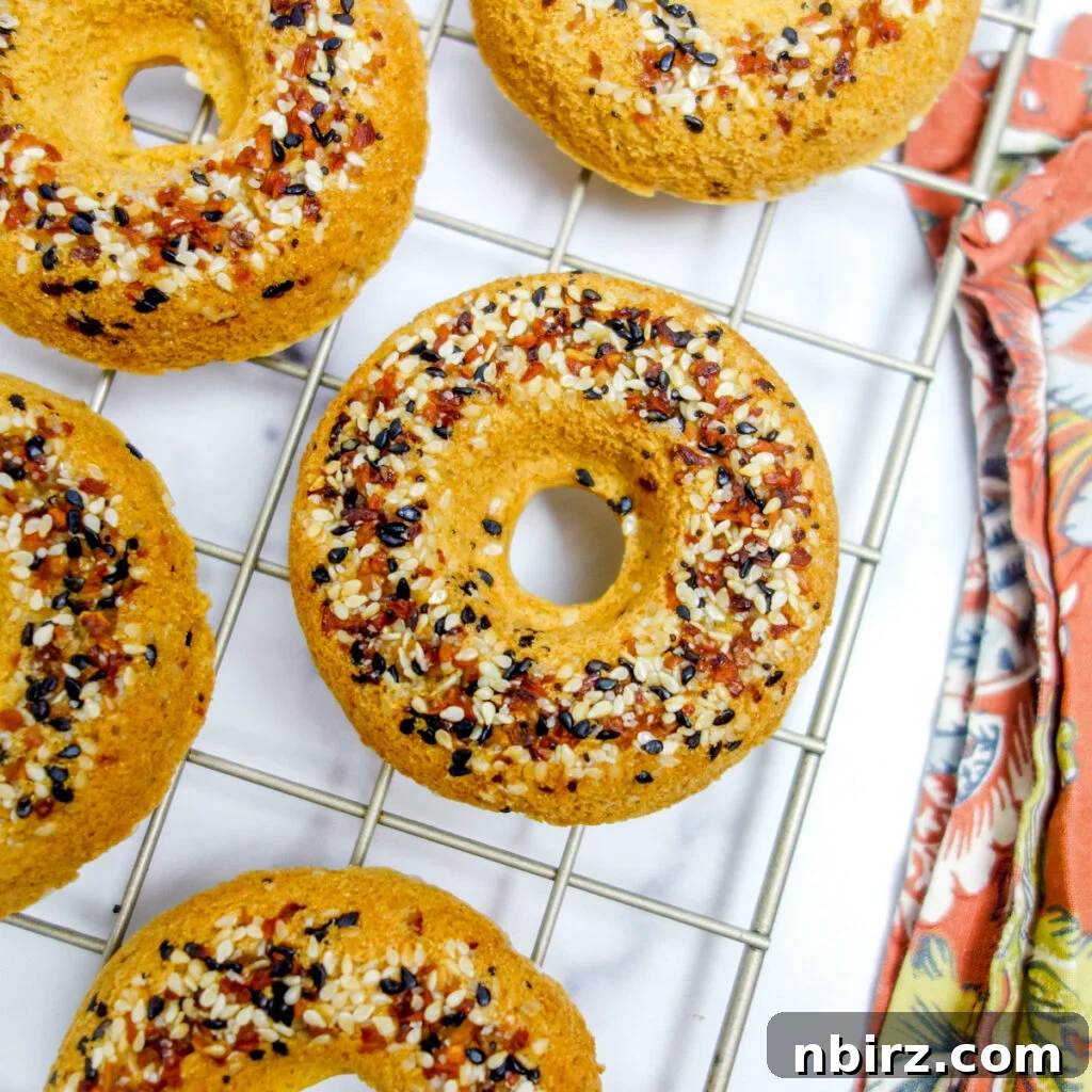 Fluffy Oil-Free Gluten-Free Vegan Chickpea Bagels 2 chickpea flour bagels on a wire cooling rack