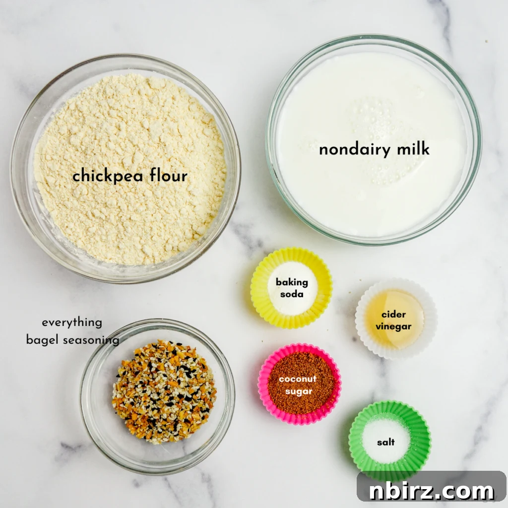 Fluffy Oil-Free Gluten-Free Vegan Chickpea Bagels 4 small glass bowls of ingredients for vegan grain-free bagels on top of a white marble board