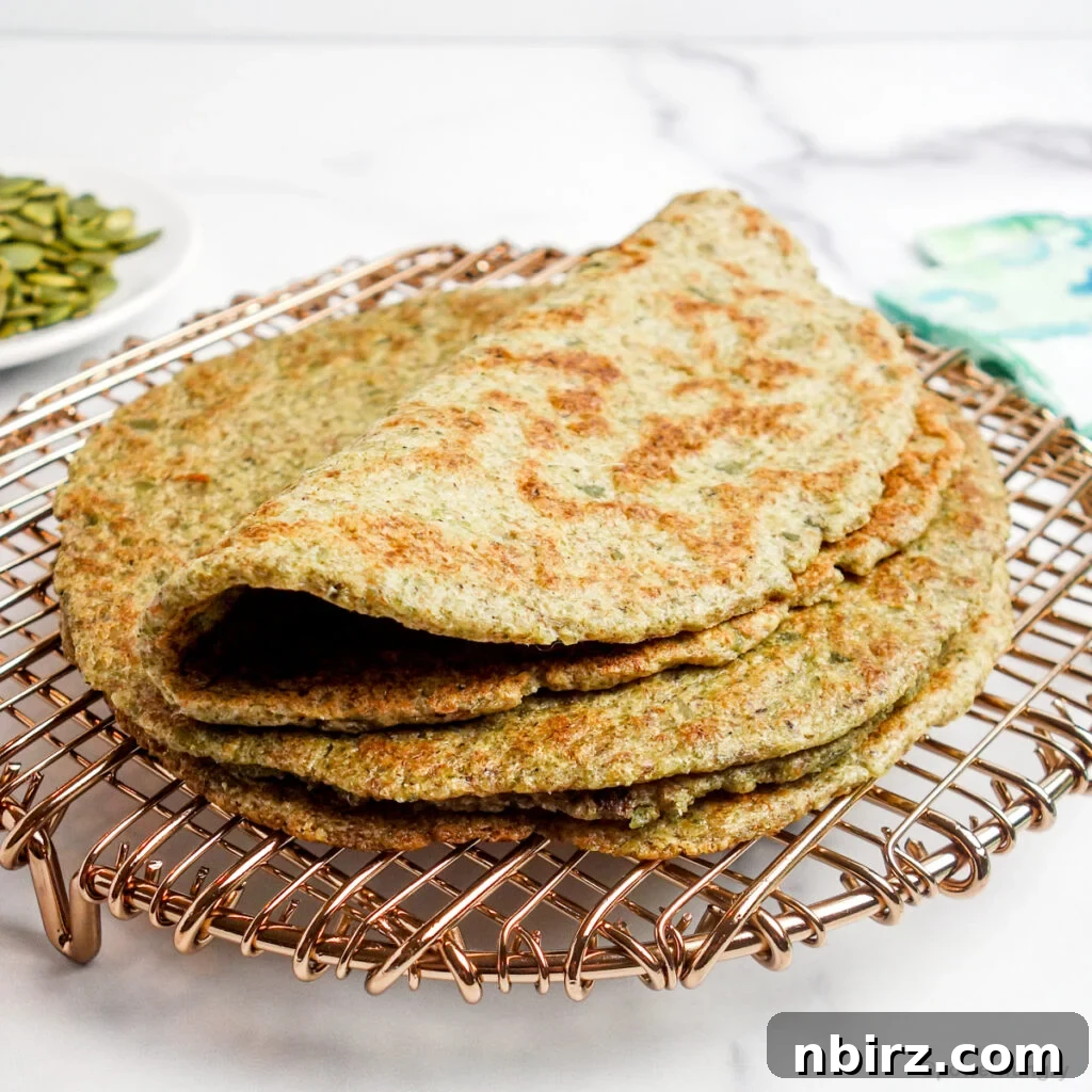 Two-Ingredient Protein-Packed Pumpkin Seed Tortillas 2 A beautiful stack of golden-brown high-protein pumpkin seed tortillas resting on a copper cooling rack, ready to be enjoyed.