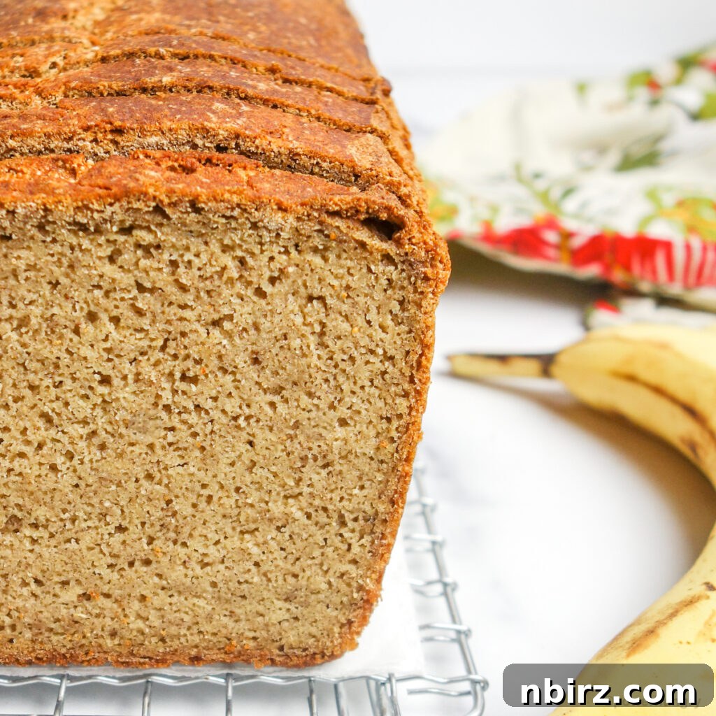 close up of a loaf of millet banana bread on a cooling rack