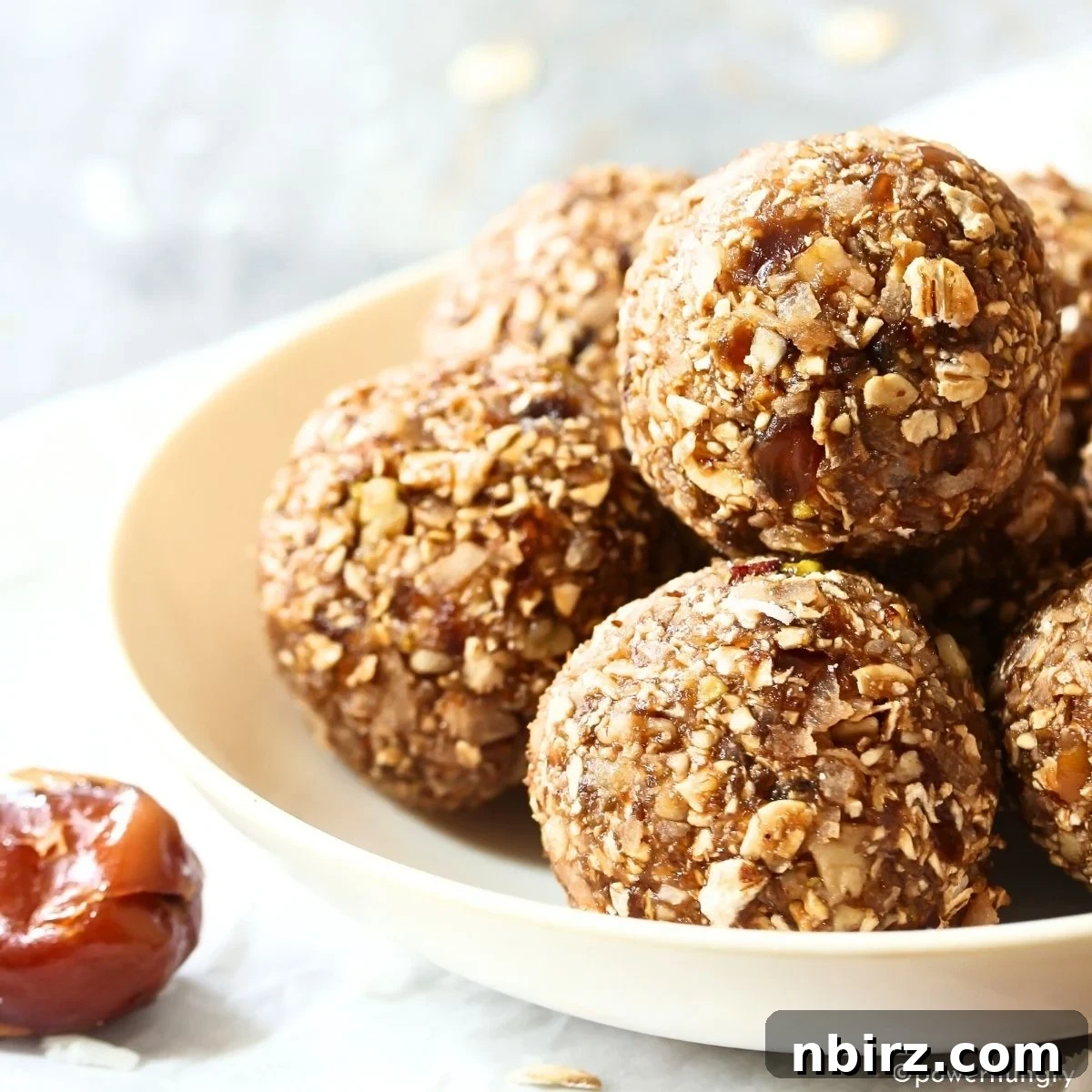 Festive Gingerbread Bliss Balls 2 Close-up of freshly made gingerbread energy balls, showcasing their textured surface and inviting color.