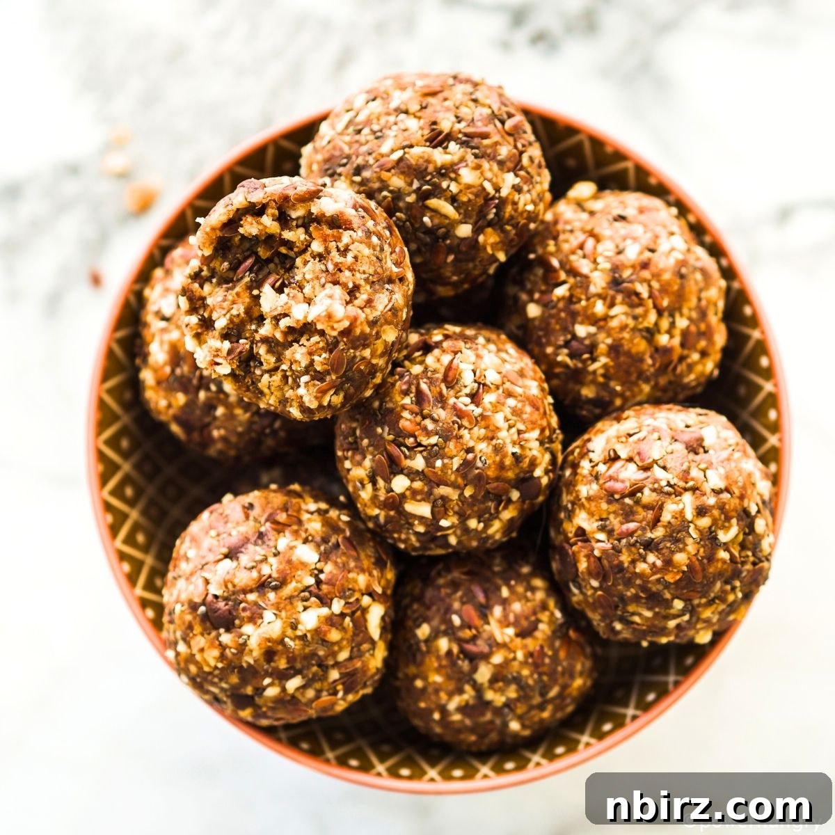 Festive Gingerbread Bliss Balls 3 Overhead shot of gingerbread energy balls neatly arranged in a wooden bowl, ready for serving.
