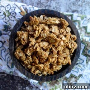 a wooden bowl filled with peanut butter granola