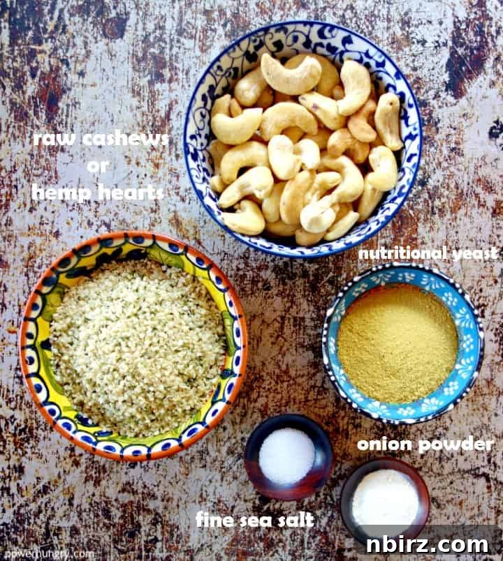 Four essential ingredients for homemade vegan parmesan cheese: raw cashews, nutritional yeast, onion powder, and sea salt.