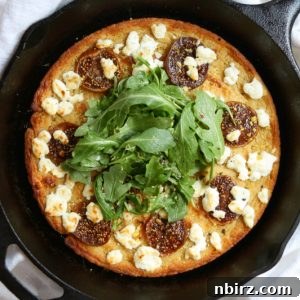 Grain Free Gluten Free Cauliflower Pizza Crust 2 A freshly baked cauliflower pizza crust in a cast iron skillet.