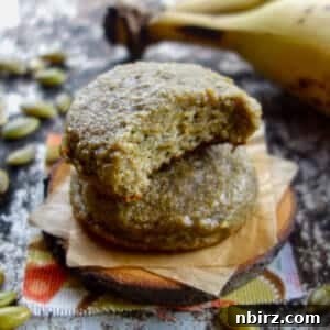 high protein pumpkin seed banana cookies stacked on a wooden disk