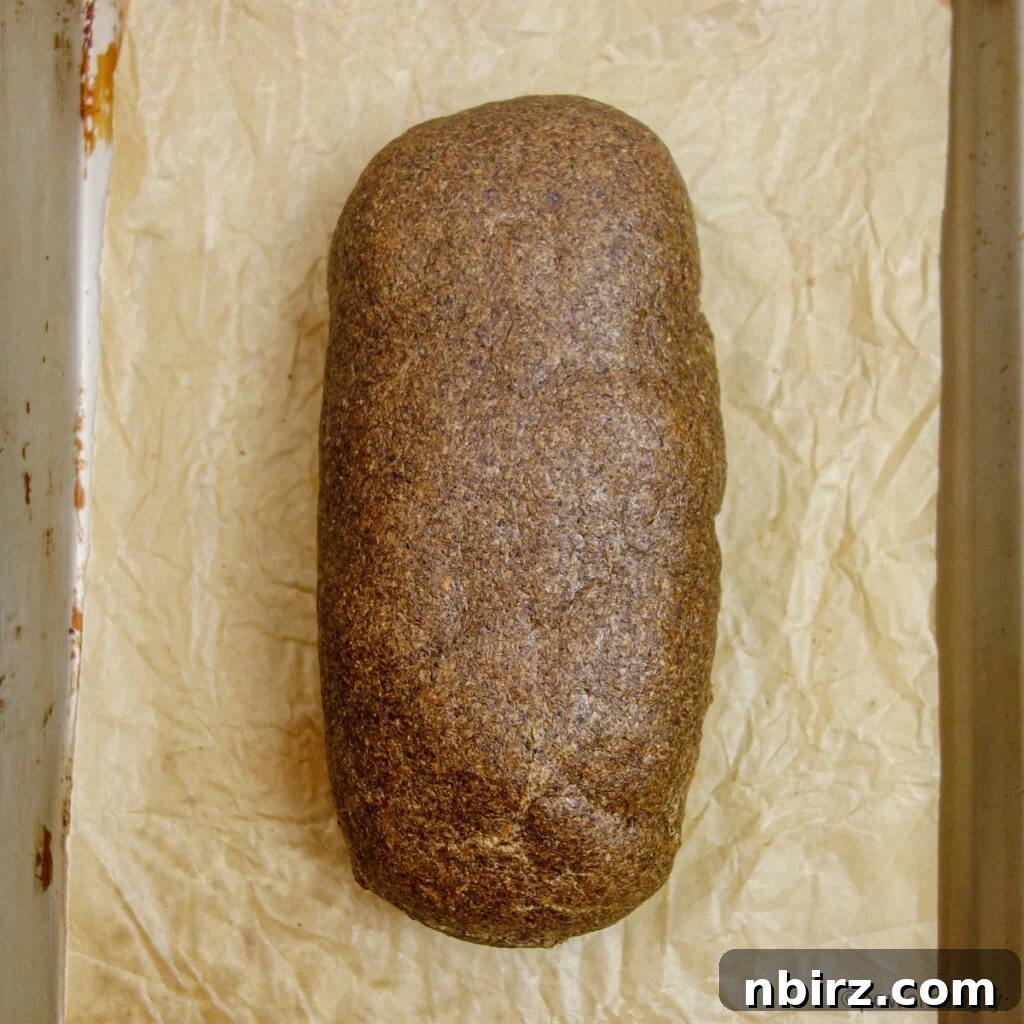 Baked loaf of 100% chia firm sandwich bread on a baking sheet
