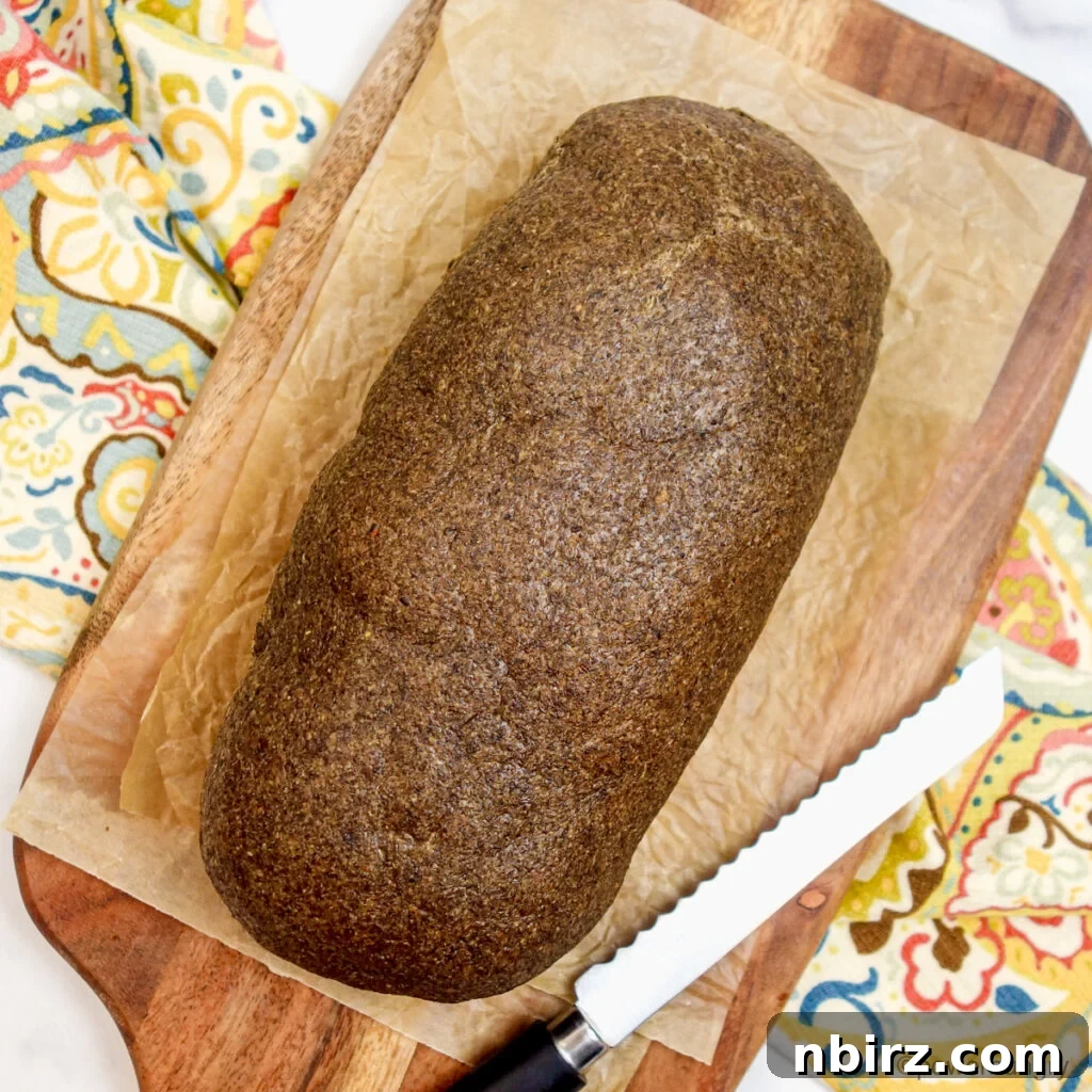 Uncut loaf of chia sandwich bread on a cutting board