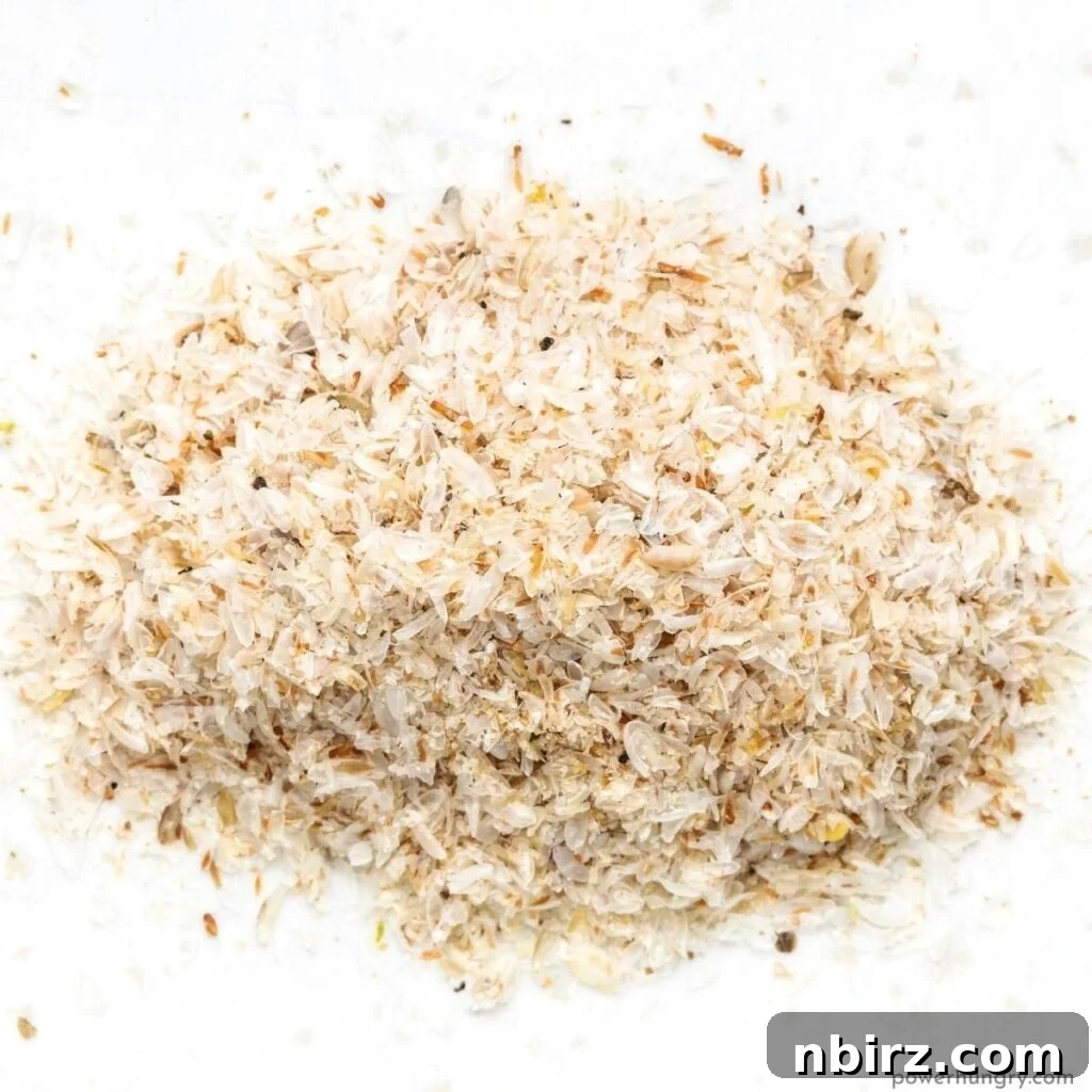 A pile of whole psyllium husks on a white background