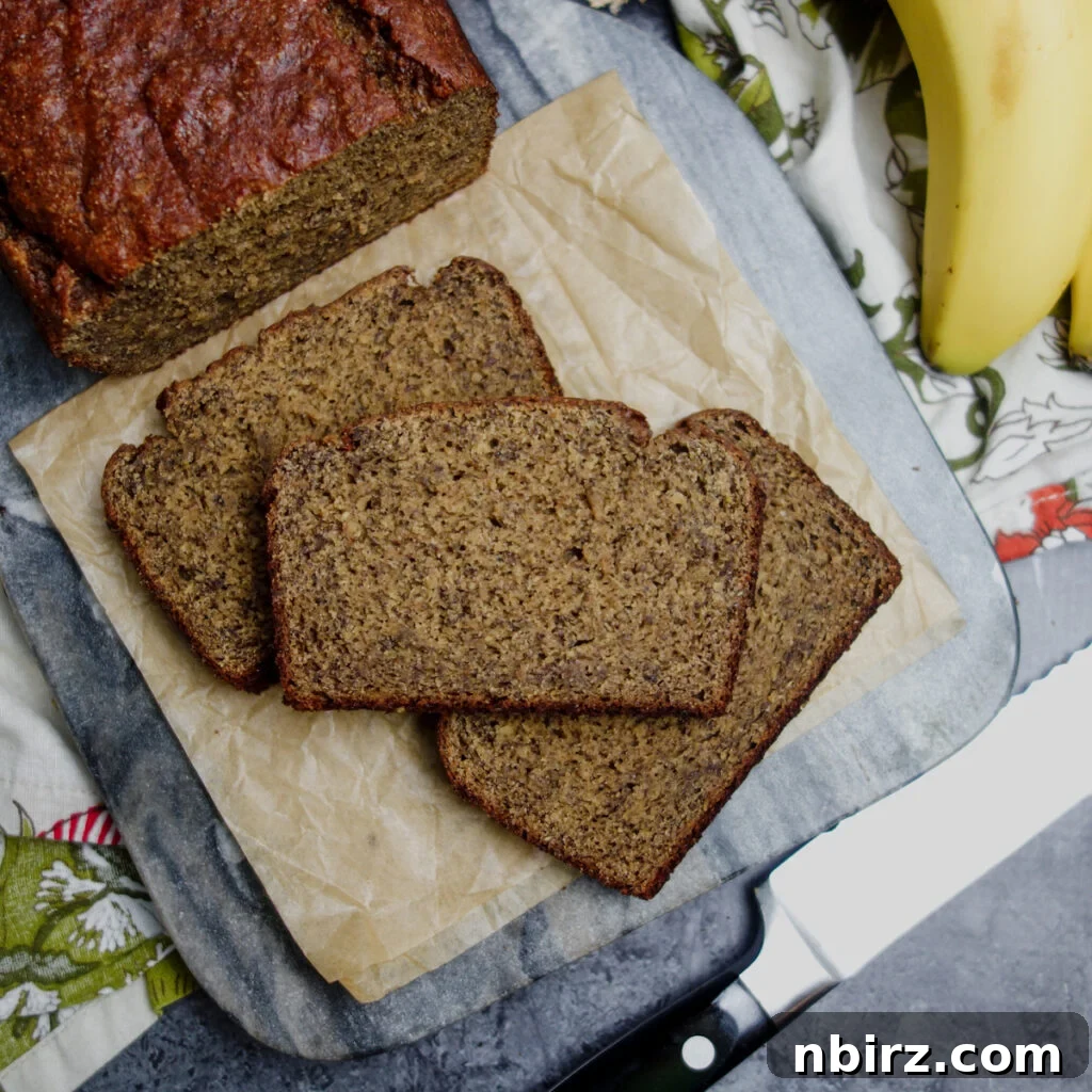 Golden Chickpea Flour Banana Bread Vegan Grain-Free Oil-Free 2 Delicious slices of vegan chickpea flour banana bread arranged on a rustic wood cutting board, ready to be enjoyed.