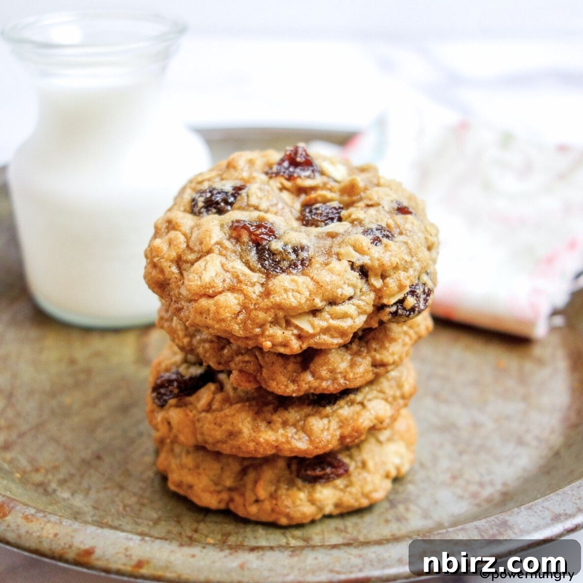 Wholesome Vegan Oatmeal Raisin Cookies No Oil No Gluten 3 A charming stack of freshly baked vegan oatmeal raisin cookies nestled in an antique pie plate, ready to be enjoyed.