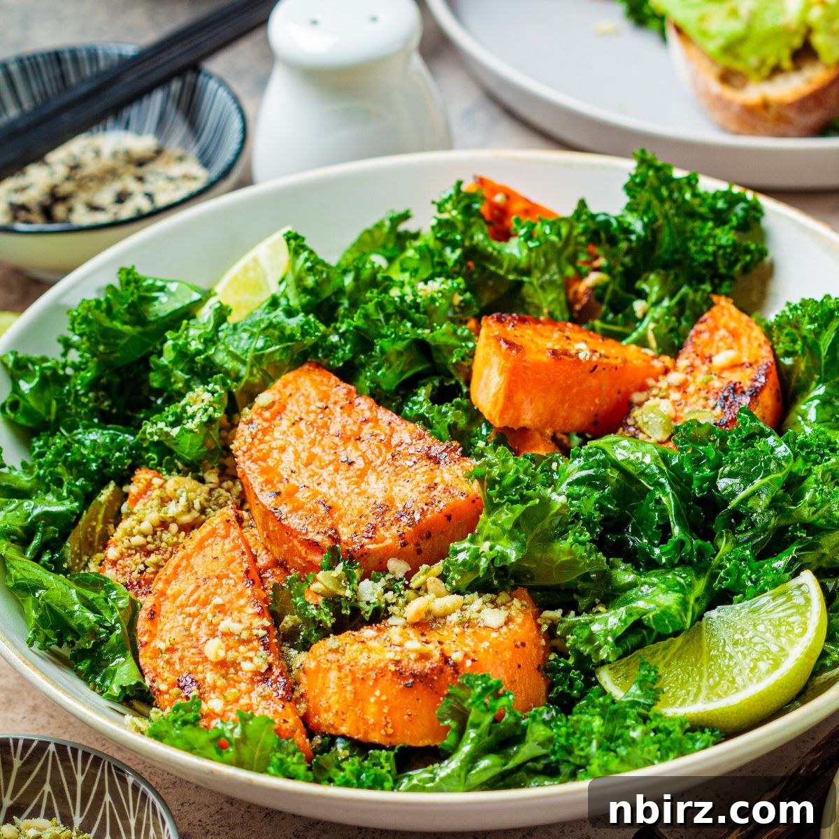 Roasted Sweet Potato & Kale Power Bowl 4 Sweet potato and kale salad in a bowl with a lime wedge, highlighting the fresh ingredients