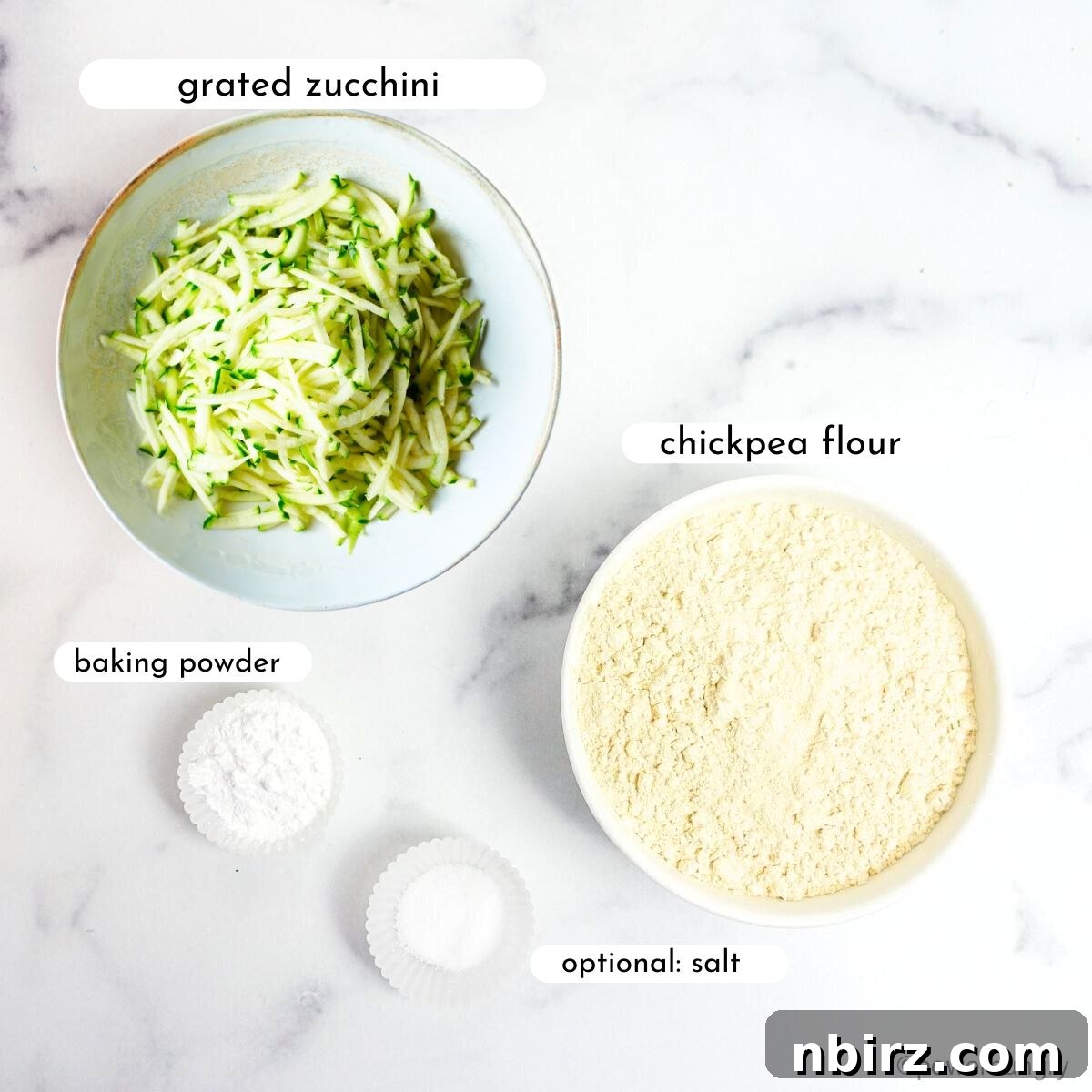 A visual display of the simple ingredients needed for 3-ingredient vegan zucchini muffins: chickpea flour, grated zucchini, and baking powder.