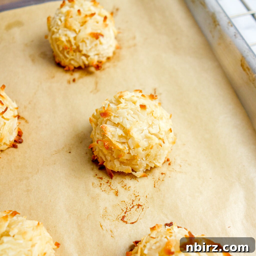 coconut macaroons, baked, on a baking sheet