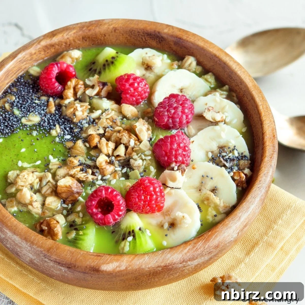 Emerald Morning Bliss 2 Green smoothie bowl topped with fresh fruits, nuts, and seeds, showcasing vibrant colors and textures for a healthy breakfast.