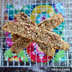 Flourless, vegan oat biscotti on a wire cooling rack with a colorful napkin