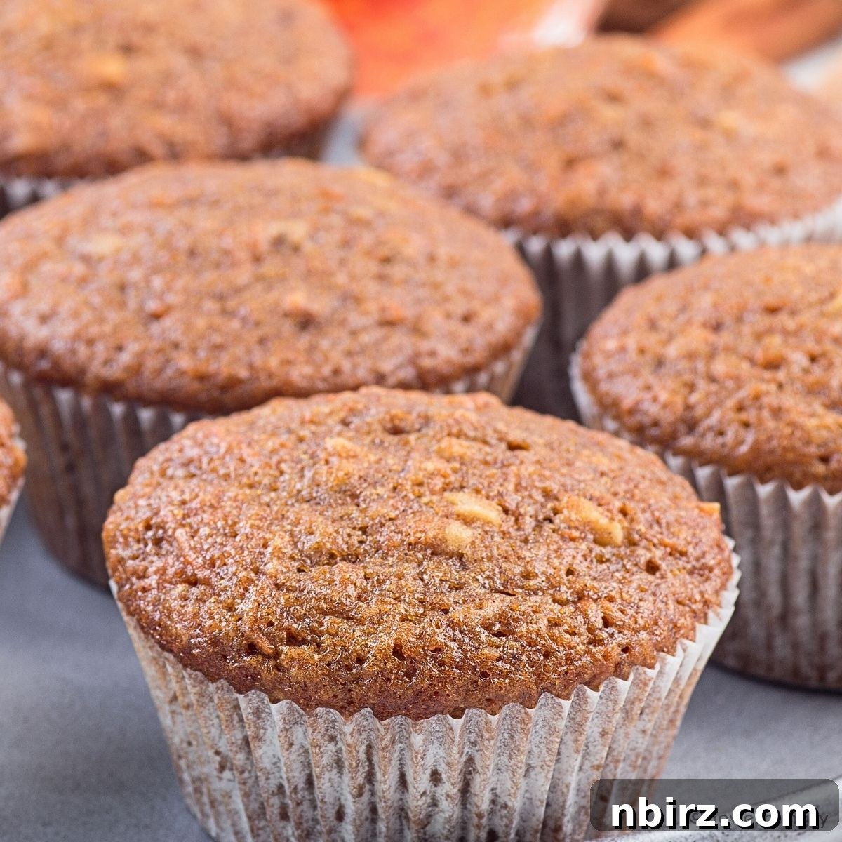 Nourishing Buckwheat Carrot Muffins 4 A close-up view of a single, perfectly baked buckwheat carrot muffin, showcasing its moist texture and specks of carrot.