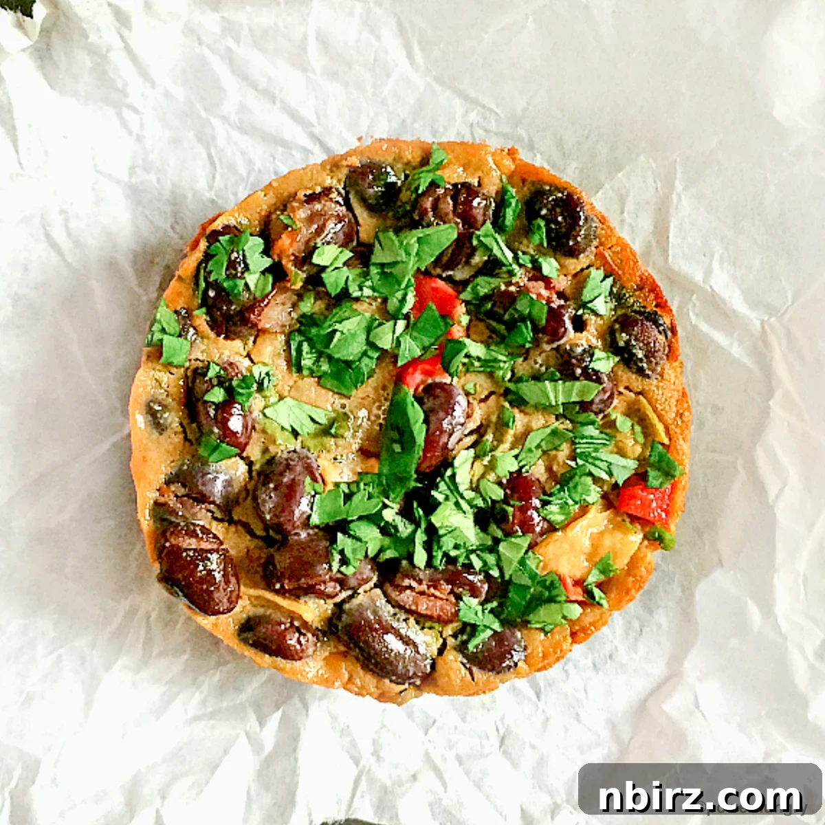Tex-Mex Black Bean Plant Protein Frittatas 2 Delicious Tex-Mex Black Bean Vegan Frittatas ready to eat, arranged beautifully on a plate, showcasing their inviting texture and ingredients.